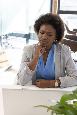 Professional Woman Concentrated on Work in Modern Office