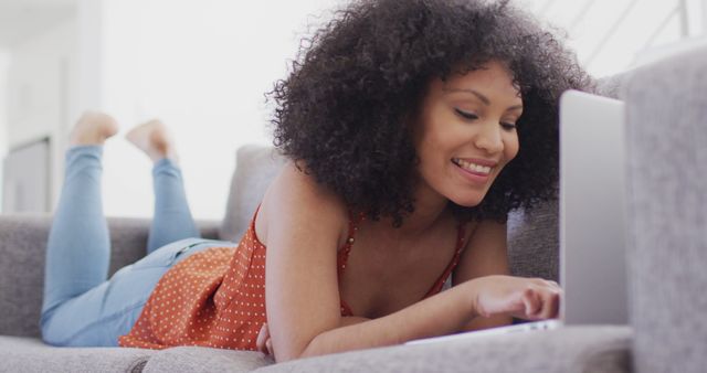 Smiling Woman Relaxing and Using Laptop on Couch at Home - Download Free Stock Images Pikwizard.com