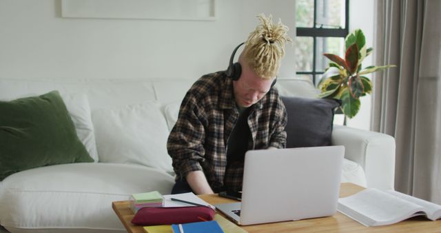 Young Man Studying at Home with Laptop and Headphones - Download Free Stock Images Pikwizard.com