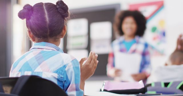 Student Raising Hand in Classroom with Teacher in Background - Download Free Stock Images Pikwizard.com