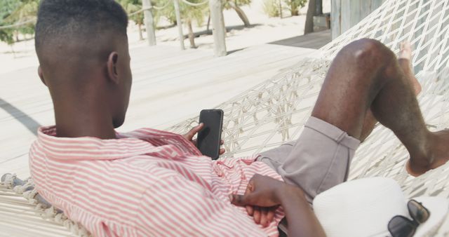 Relaxing Young Man on Hammock Using Smartphone Outdoor - Download Free Stock Images Pikwizard.com