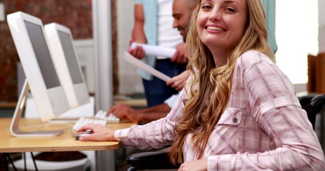 Smiling Woman in Wheelchair Working on Computer in Office - Download Free Stock Images Pikwizard.com