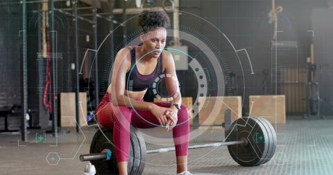 Exhausted Athlete Analyzing Performance Data at Gym