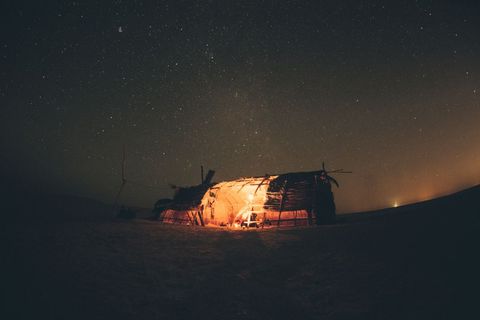 Traditional Hut with Warm Light Under Night Sky, Beautiful Starlit Night in Desert - Download Free Stock Images Pikwizard.com