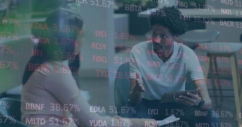 Colleagues Engaged Over Tablet with Stock Tickers in Office