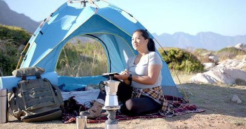 Woman Camping with Tent in Scenic Mountain Landscape