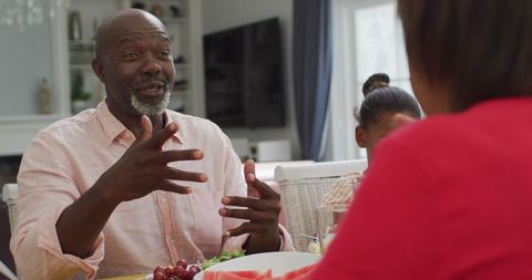 Joyful African American Family Sharing Lunchtime at Home
