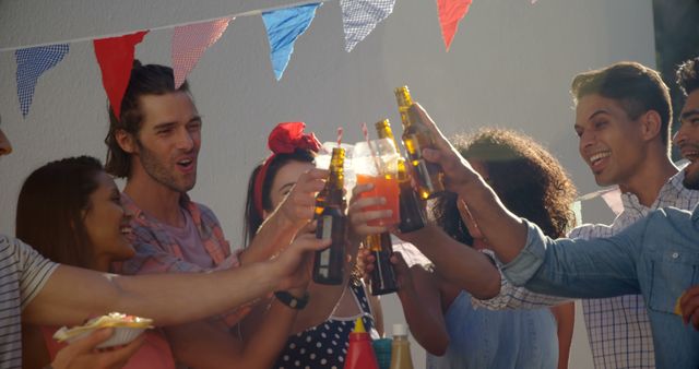 Group of Friends Celebrating at Outdoor Party with Drinks and Laughter - Download Free Stock Images Pikwizard.com