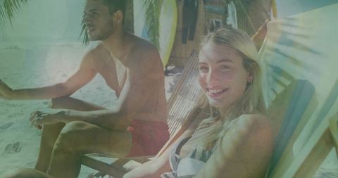 Couple Relaxing on Tropical Beach with Surfboards and Sunshine