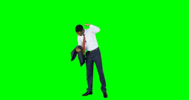 Businessman removing suit jacket isolated on green screen is ideal for editing projects needing a professional look. Perfect for business presentations, advertisements, and corporate training videos requiring flexible background options.