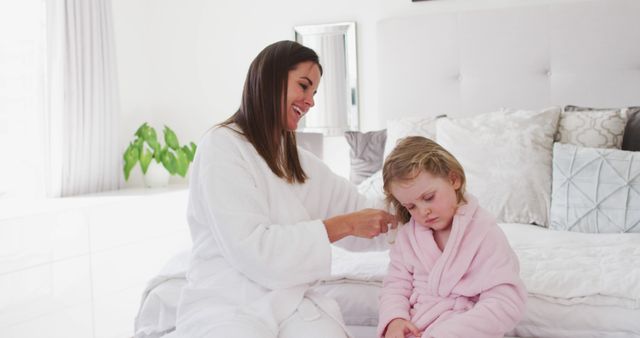 Caring Mother Brushing Daughter's Hair in Cozy Bedroom - Download Free Stock Images Pikwizard.com