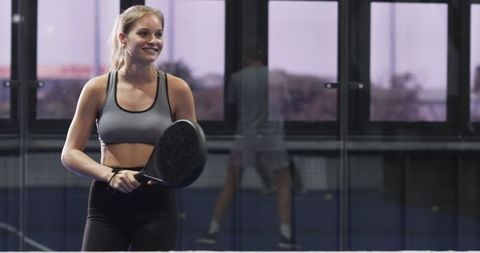 Female Padel Trainer on Indoor Court during Training Session