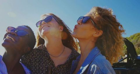 Joyful Friends Enjoying Road Trip in Convertible
