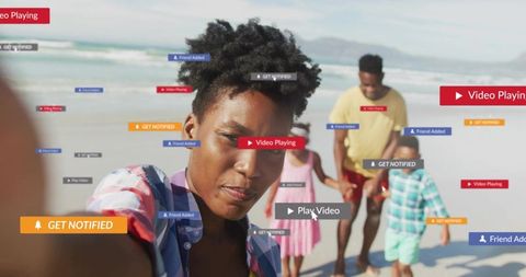 Taking beach selfie while family walking with social media notifications and play video overlays