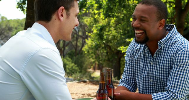 Two Friends Smiling and Talking During Picnic Outdoors - Download Free Stock Images Pikwizard.com