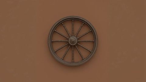 Rustic wooden wagon wheel on brown wall