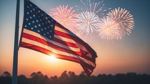American flag waving at sunset with fireworks in twilight