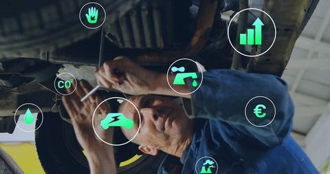 Mechanic repairing car with futuristic digital icons