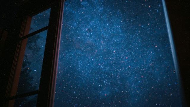 Open window frame revealing starry night sky