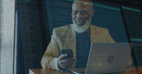 Business professional analyzing code on devices in office