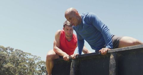 Fit Men Conquering Outdoor Obstacle Course Together