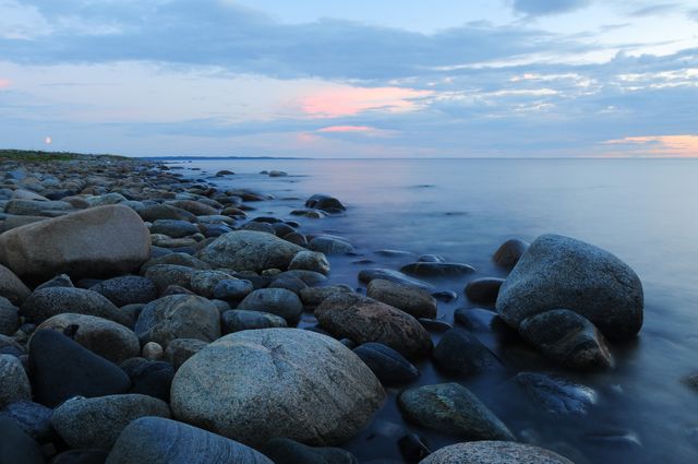 Rocky Beach Coastline at Sunset with Smooth Pebbles and Calm Ocean Waves - Download Free Stock Photos Pikwizard.com