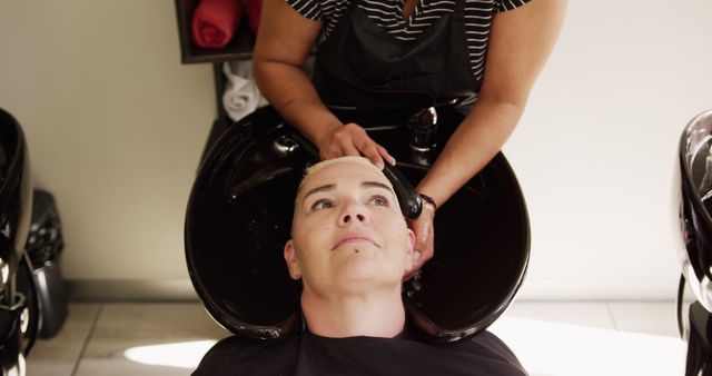 Person Relaxing During Professional Hair Washing in Salon - Download Free Stock Images Pikwizard.com