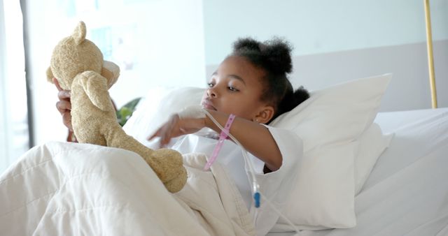 Young Child in Hospital Bed Playing with Teddy Bear - Download Free Stock Images Pikwizard.com