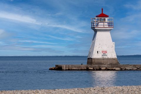 Iconic Lighthouse by Tranquil Sea Under Clear Sky