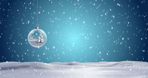 Festive Christmas Bauble Hanging Against Snowy Winter Wonderland