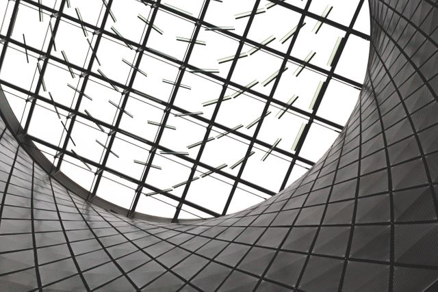 This dynamic photo of modern architectural features highlights the sleek and innovative design of the interior skylight with geometric patterns. Perfect for use in design magazines, architecture presentations, marketing materials, and blog posts about contemporary art and design concepts.