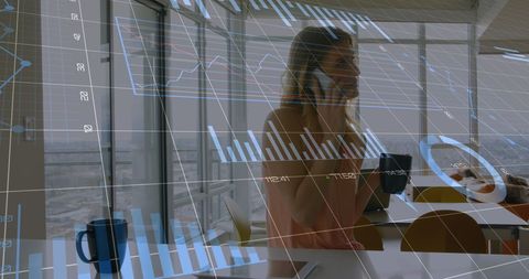 Businesswoman analyzing financial growth with graph overlays