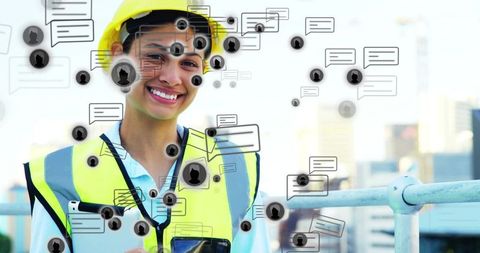 Construction engineer using tablet on rooftop with digital chat overlays and safety gear