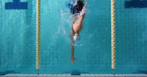 Underwater swimmer training in clear blue pool