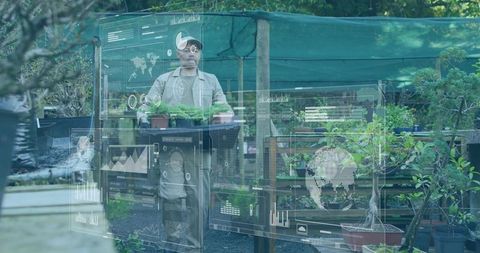 Nursery worker using augmented reality interface while handling seedling trays