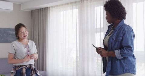 Happy Women Packing for Travel at Home Decision Making Point Arranging Outfits