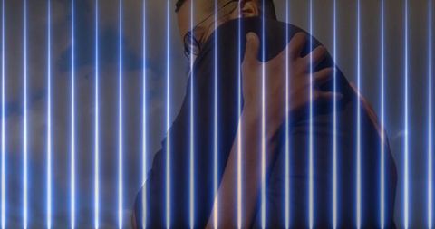 Romantic embrace in blue neon installation setting