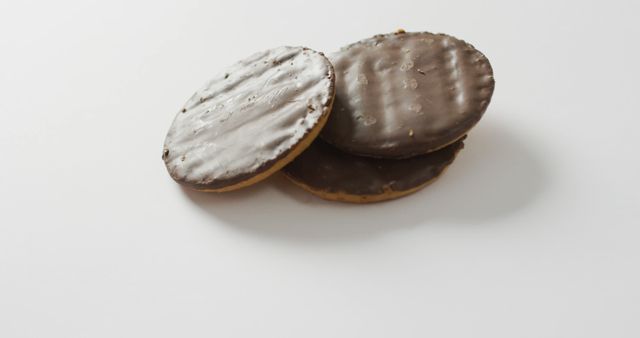 Close-Up of Three Chocolate-Covered Biscuits on White Surface - Download Free Stock Images Pikwizard.com