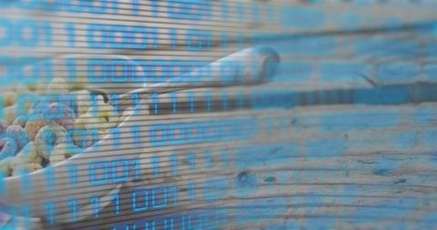 Displaying white bowl of ring cereal with blue binary overlay on rustic wood table