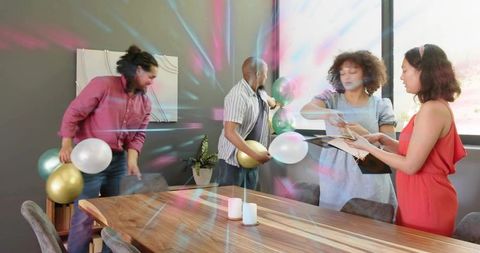 Diverse team decorating conference room for office celebration with balloons and candles