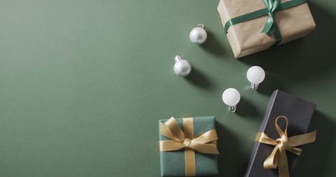 Festive Gifts and Baubles on Green Background with Space - Download Free Stock Images Pikwizard.com