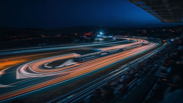 Night Racetrack Featuring Dynamic Light Trails Depicting Speed