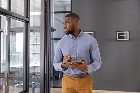 Professional man using tablet in modern office