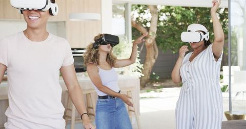 Friends Immersed in Virtual Reality Experience at Home