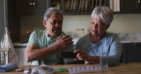 Seniors using smartphone for online health consultation at home