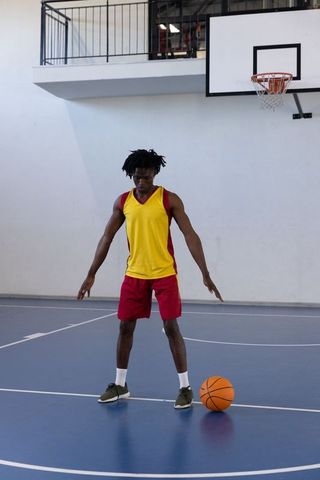 Confident Athlete Preparing for Basketball Game in Gym Court Fashion