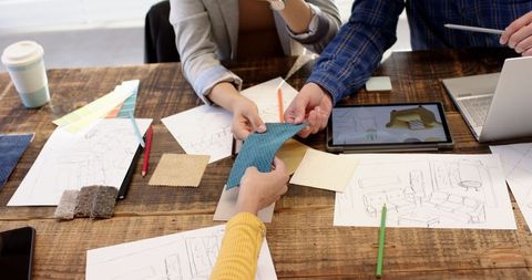 Collaborative Creative Design Meeting with Fabrics and Sketches