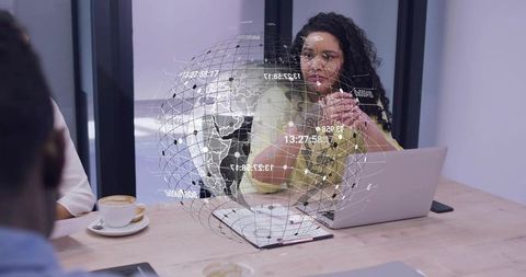 Curly businesswoman presenting digital globe data visualization during team meeting