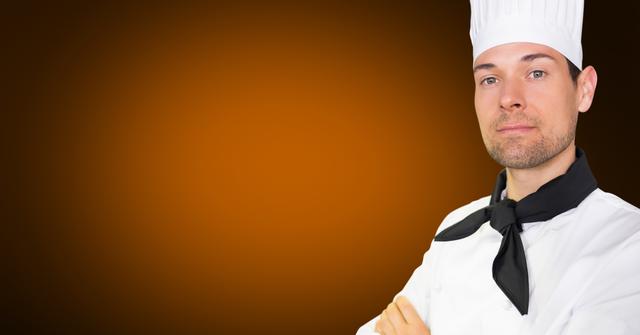 Portrait of chef with his arms crossed against orange background