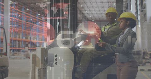 African American Workers Analyzing Data in Warehouse